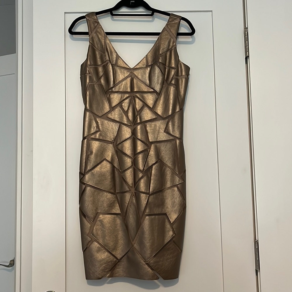 bronze dress with geometric design and illusion in between. Fully lined.